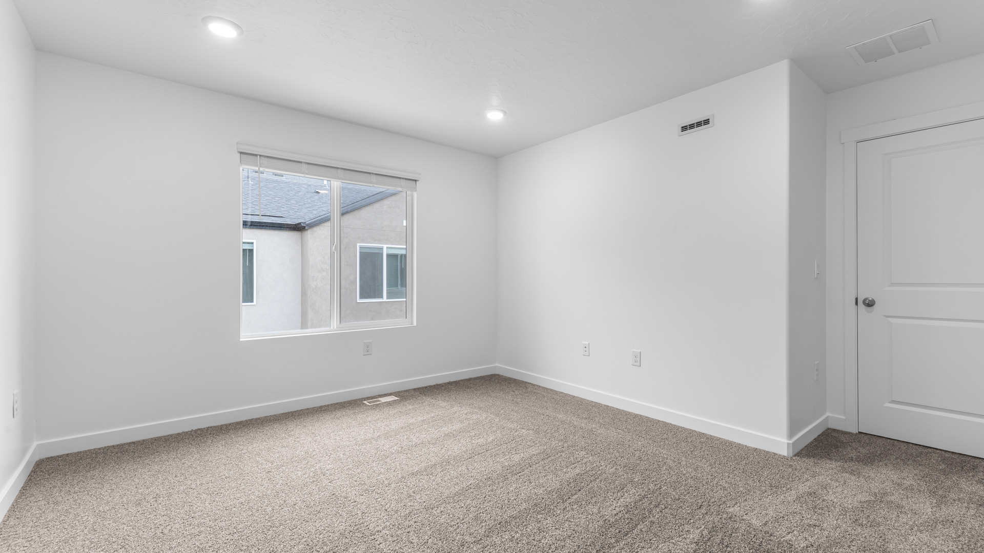 Primary bedroom with large window.