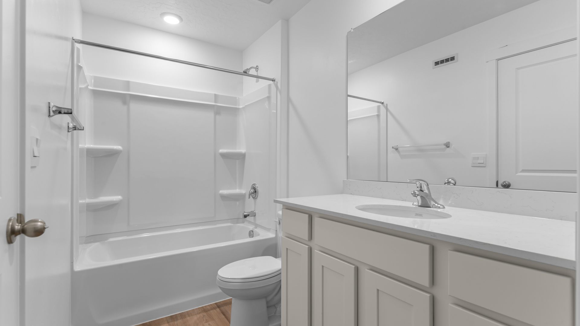 Primary bathroom with shower surround.