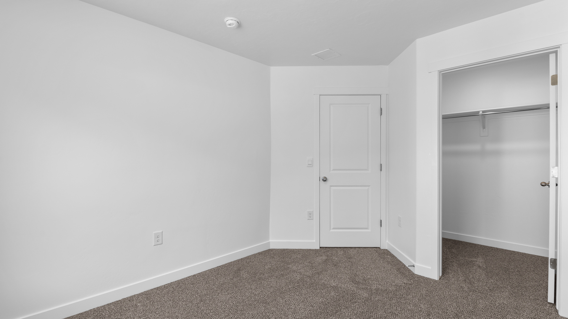 Primary bedroom with large windows