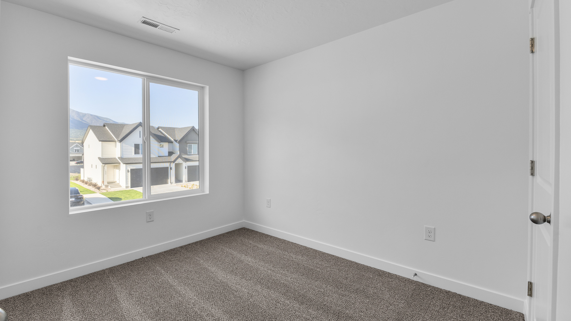 Primary bedroom with large windows