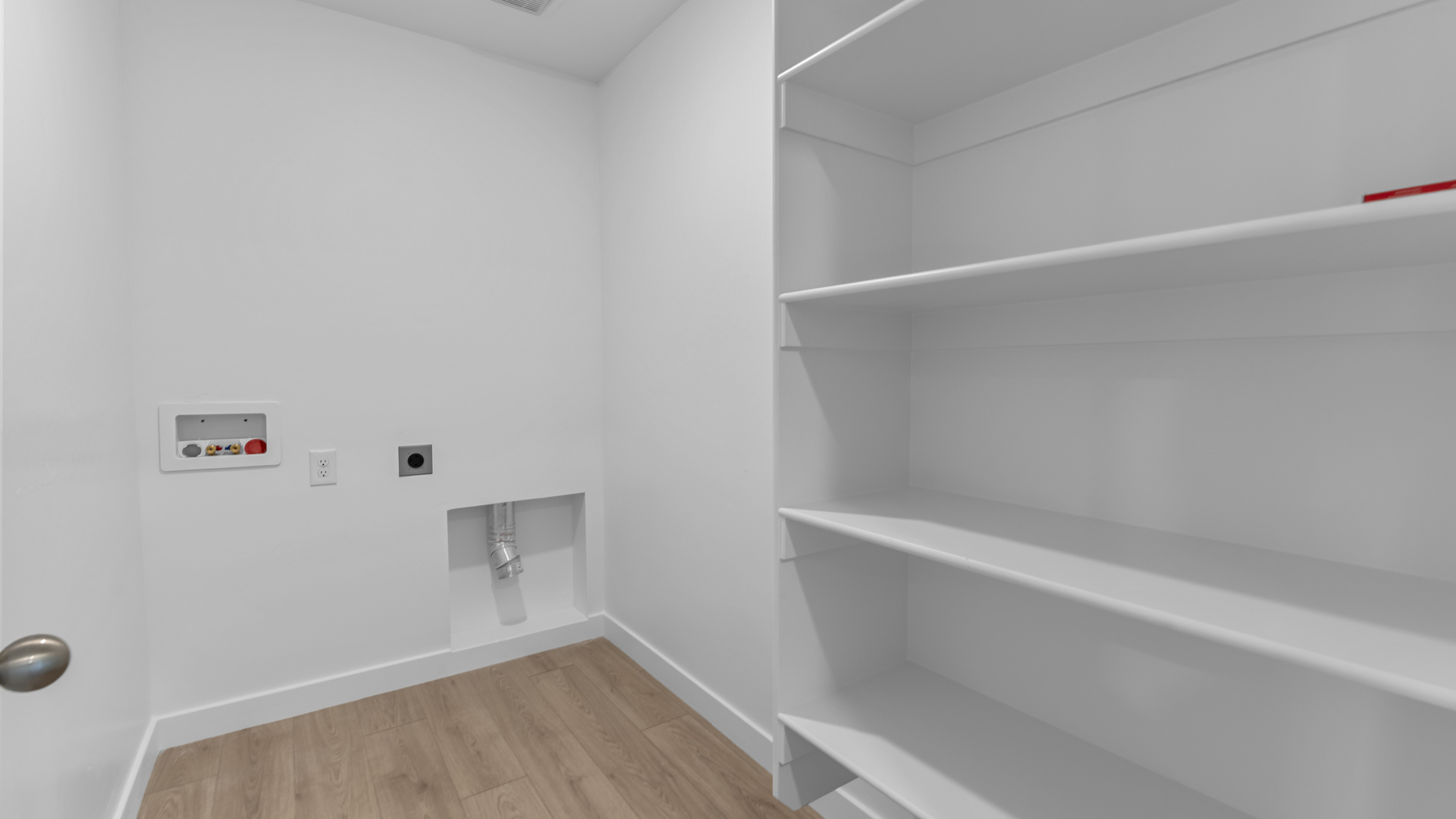 Laundry area behind double doors in hallway