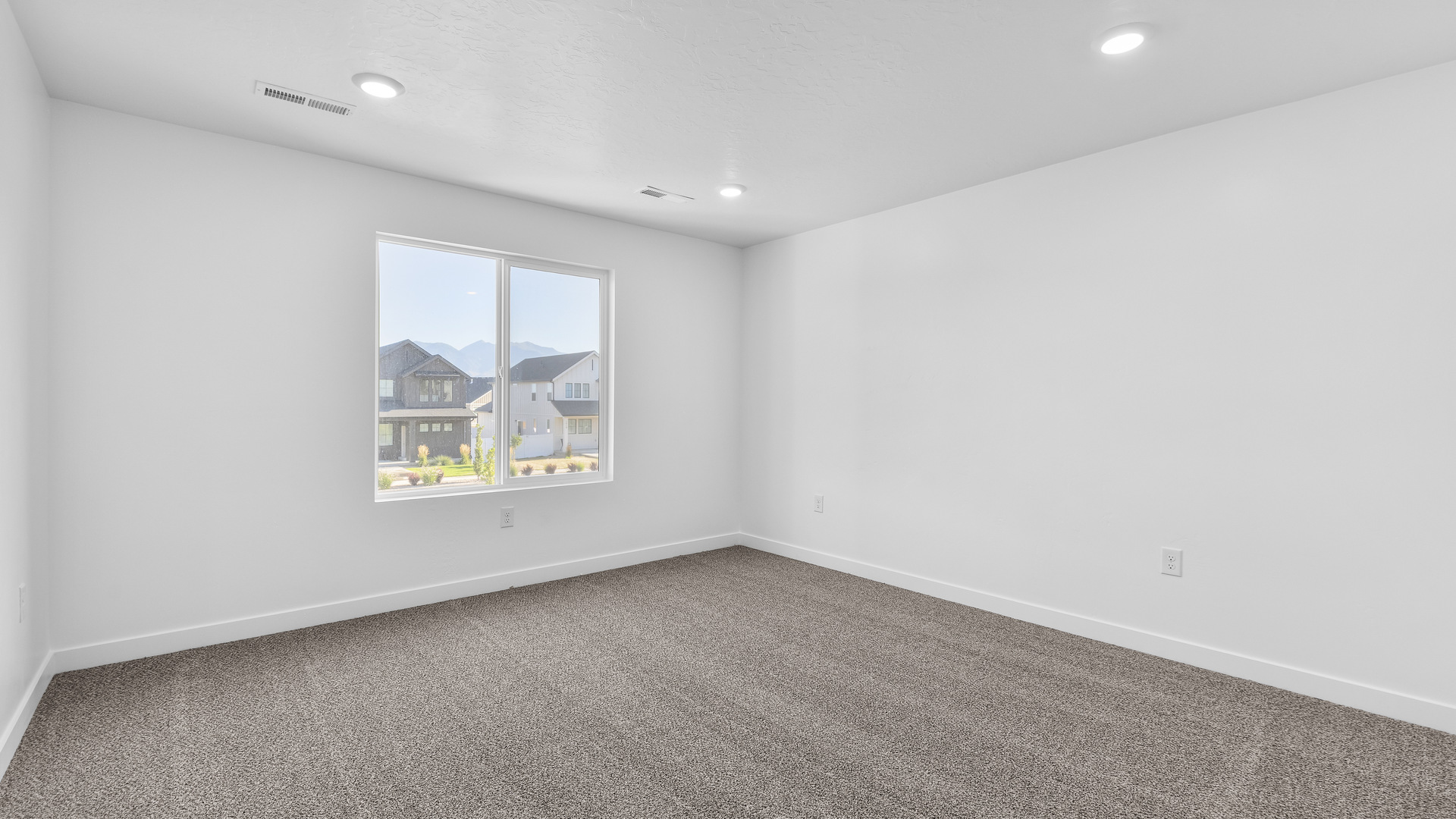 Primary bedroom with large windows