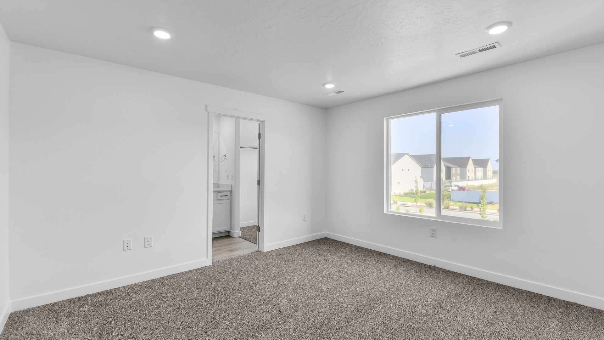 Primary bedroom with large windows