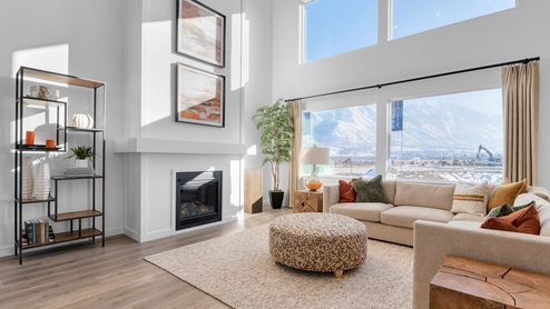 Family room with two story vaulted ceiling with floor to ceiling picture windows with a cozy fireplace