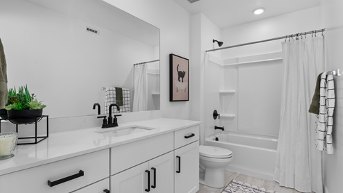 Spacious bathroom with a large quartz countertop and window.