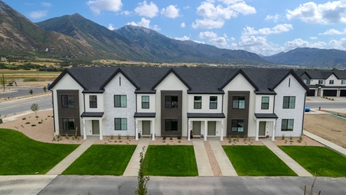 Viridian community aerial showcasing homes being built and mountains.
