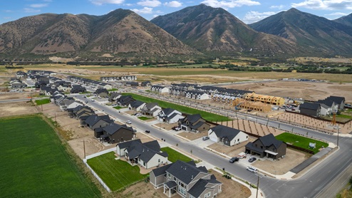 Viridian community aerial showcasing homes being built and mountains.