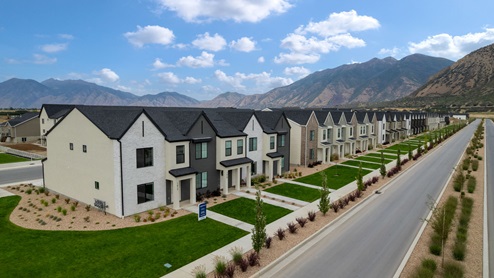 Viridian community aerial showcasing homes being built and mountains.