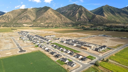 Viridian community aerial showcasing homes being built and mountains.