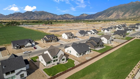 Viridian community aerial showcasing homes being built and mountains.