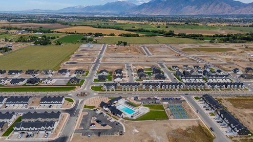 Viridian community aerial showcasing homes being built, clubhouse, and mountains.