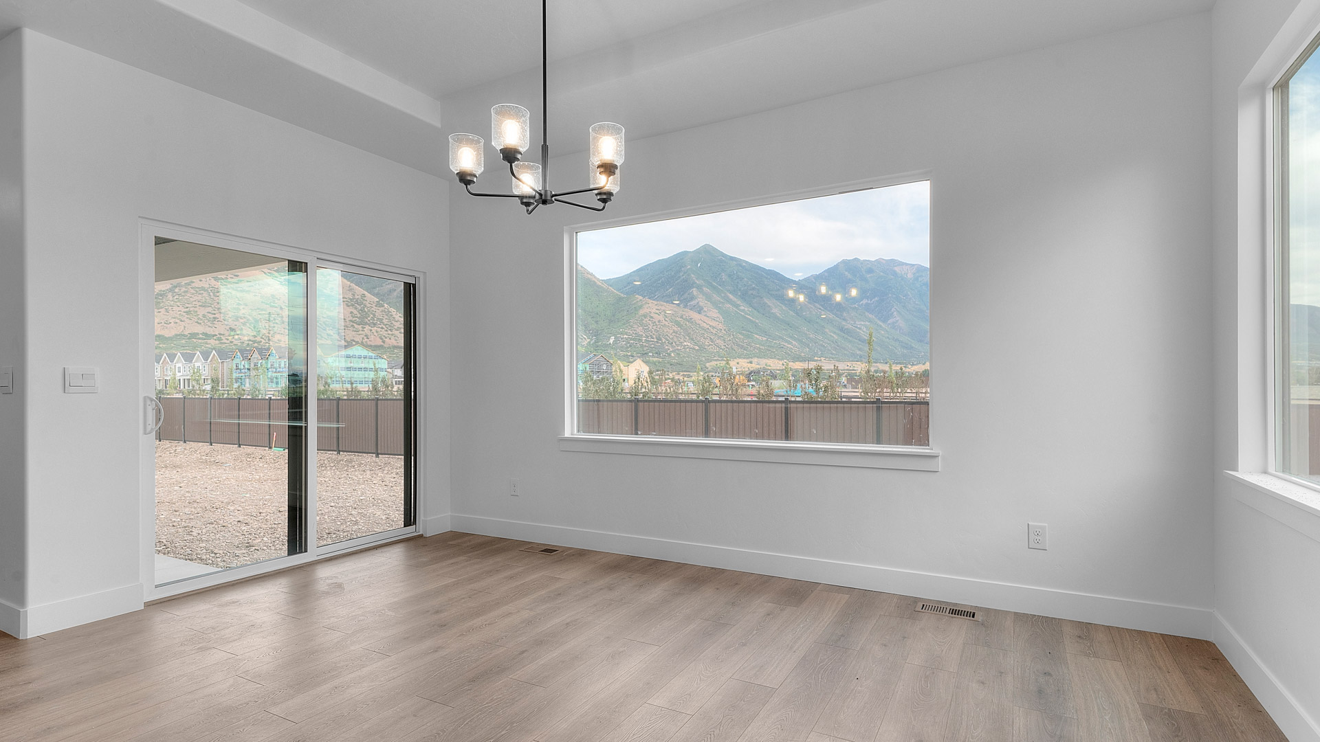 Dining room with patio doors and large windows.