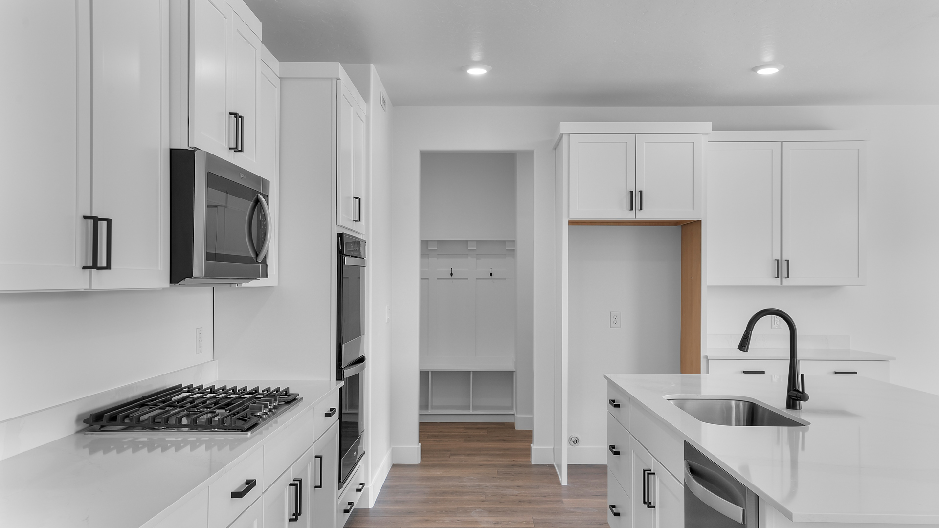 White kitchen cabinets and countertops in kitchen of home