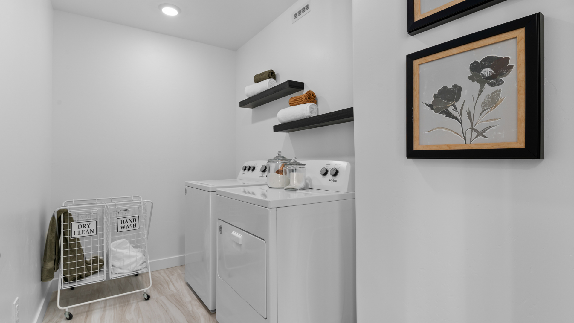 Laundry room with window and hard surface flooring