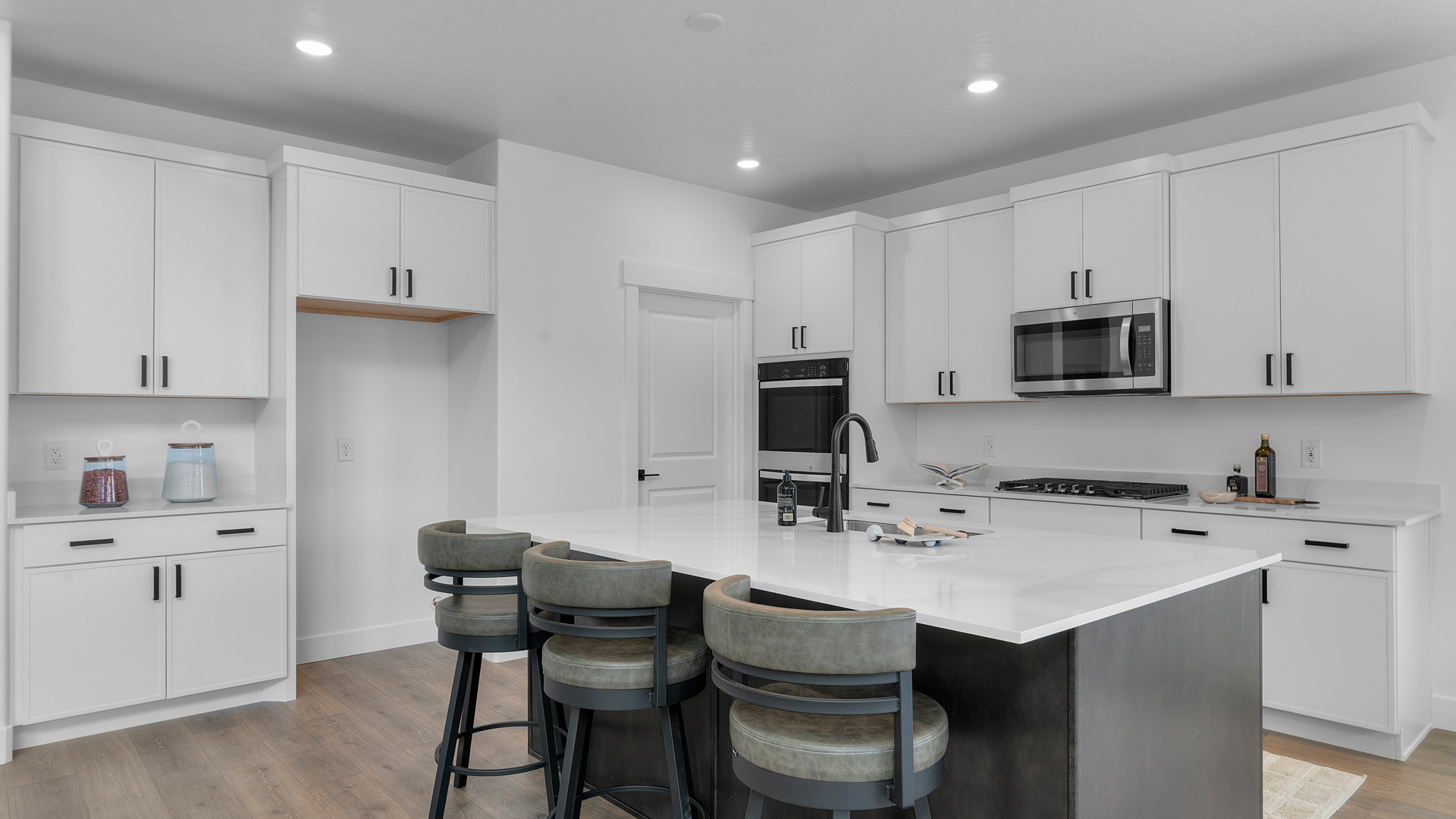 Kitchen space with dark cabinets and kitchen island.