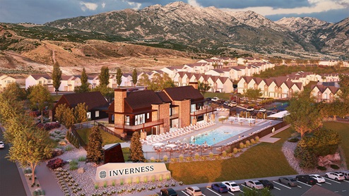 Aerial view of the Inverness main community sign and clubhouse with pool area.