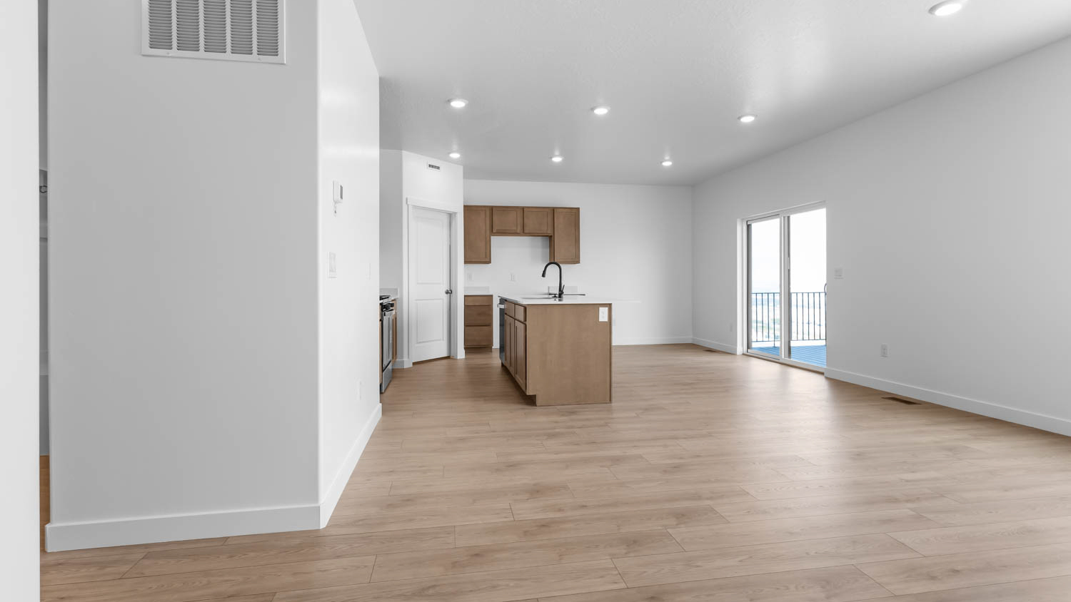 Family room, dining, and kitchen with large window.
