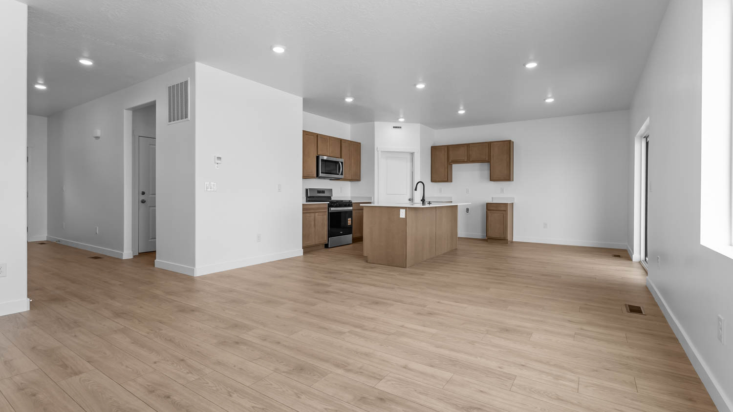 Family room, dining, and kitchen with large window.