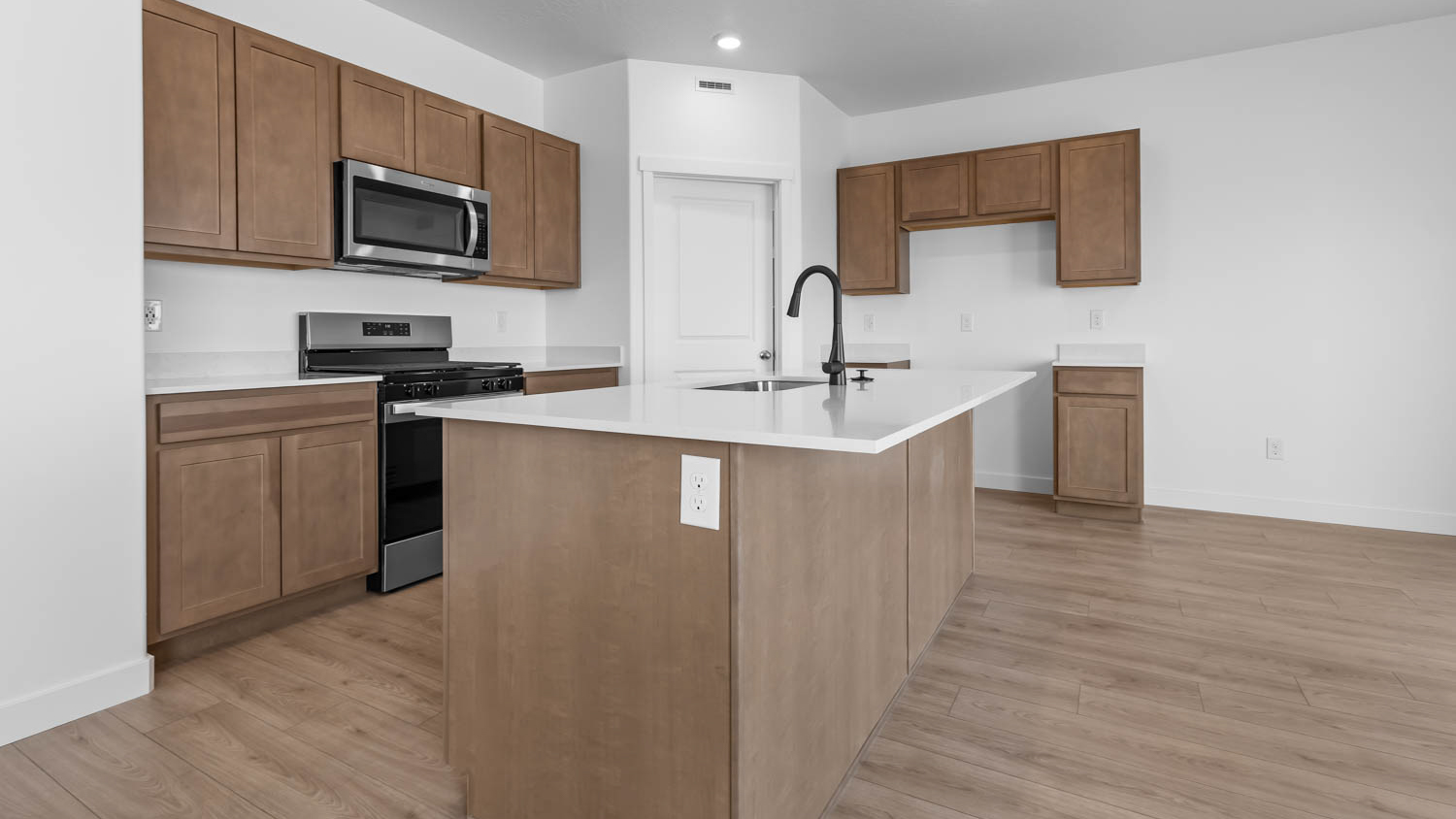 Kitchen with kitchen island and cabinets.