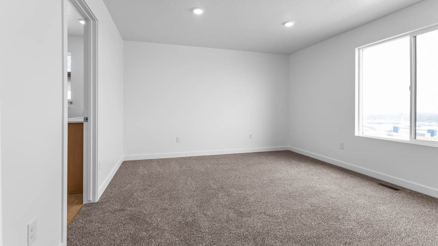 Primary bedroom with large window.Primary bedroom with large window.