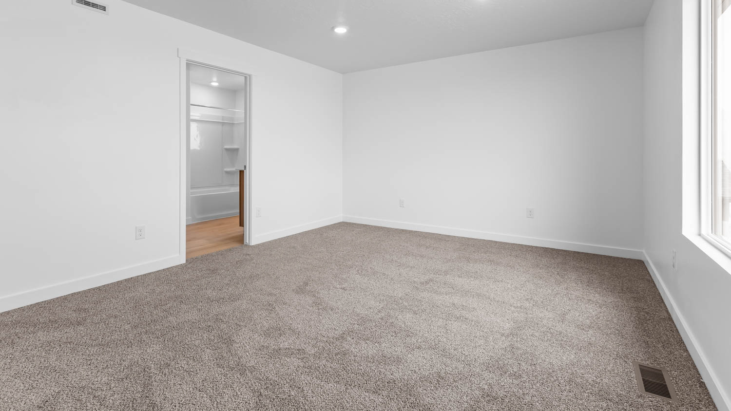 Primary bedroom with large window.