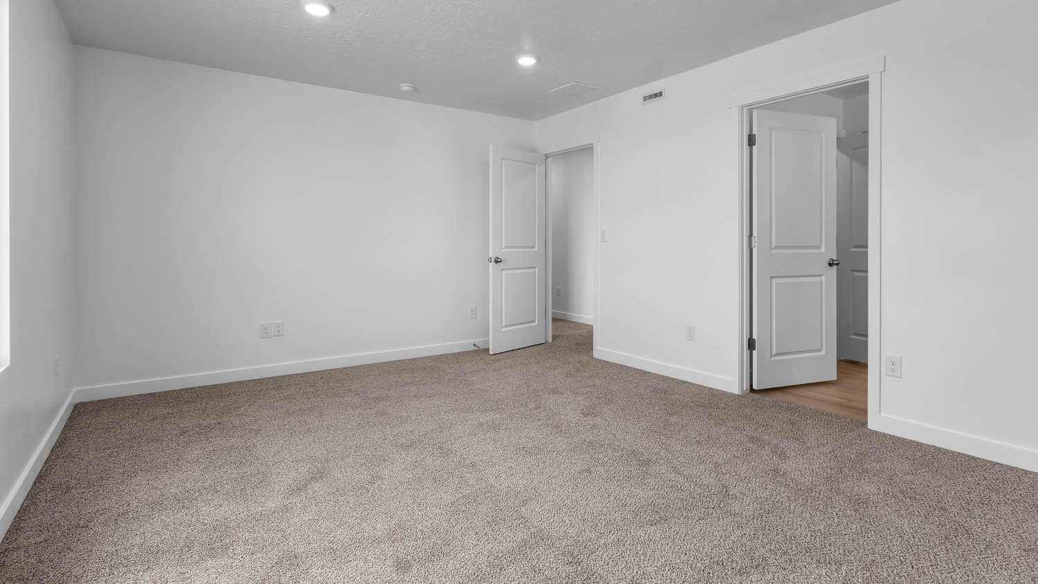 Primary bedroom with large window.