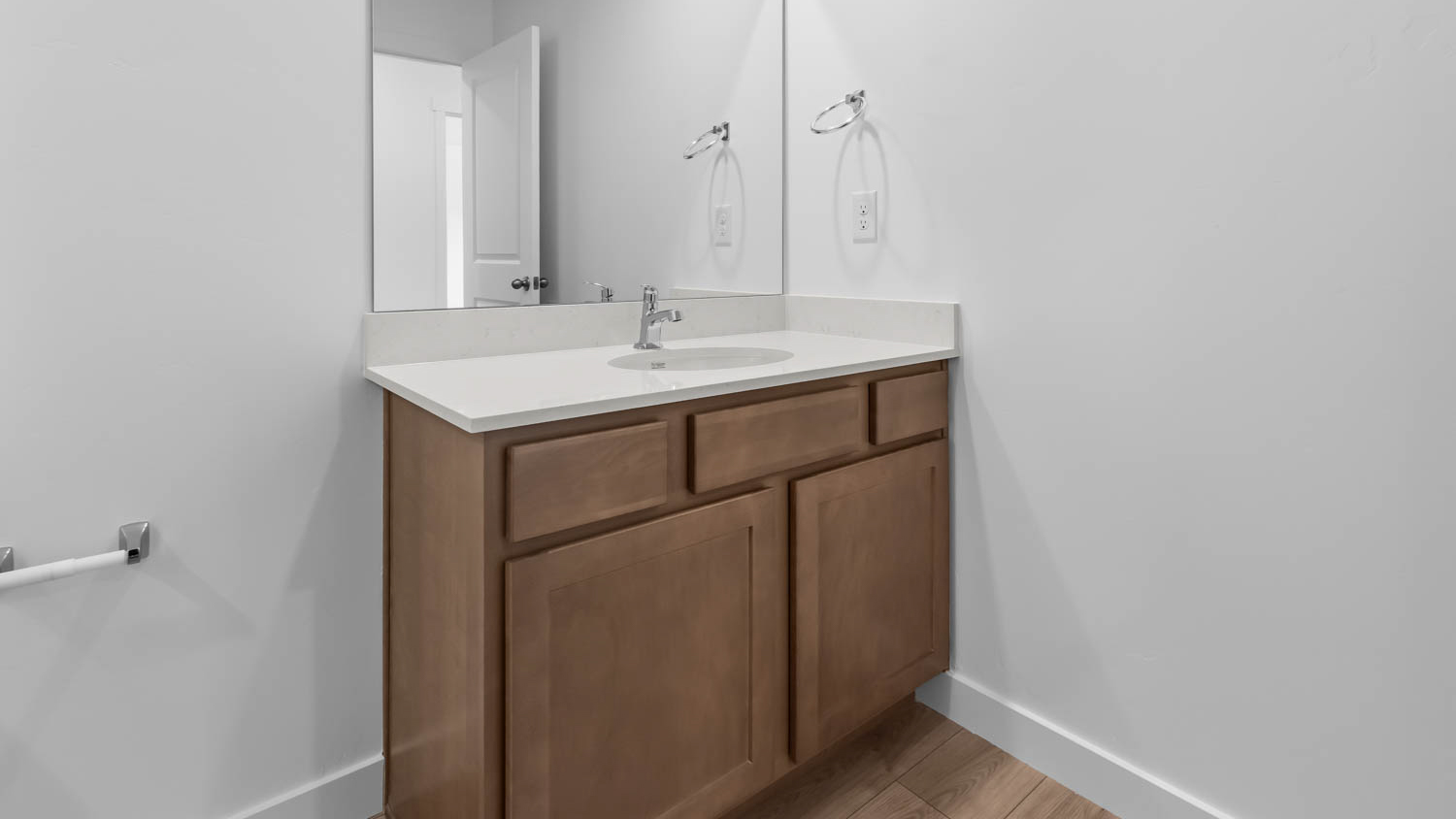 Bathroom with vanity and shower surround.