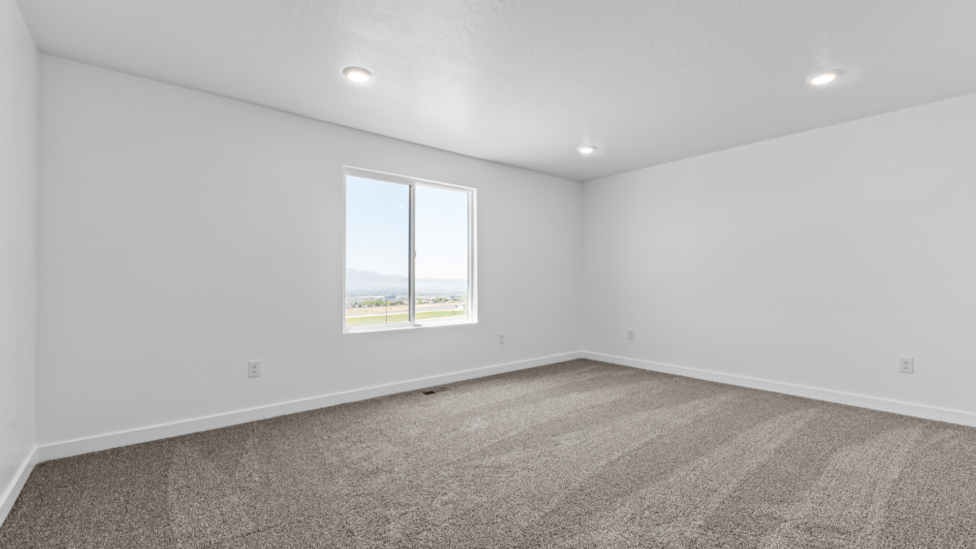 Primary bedroom with large window.