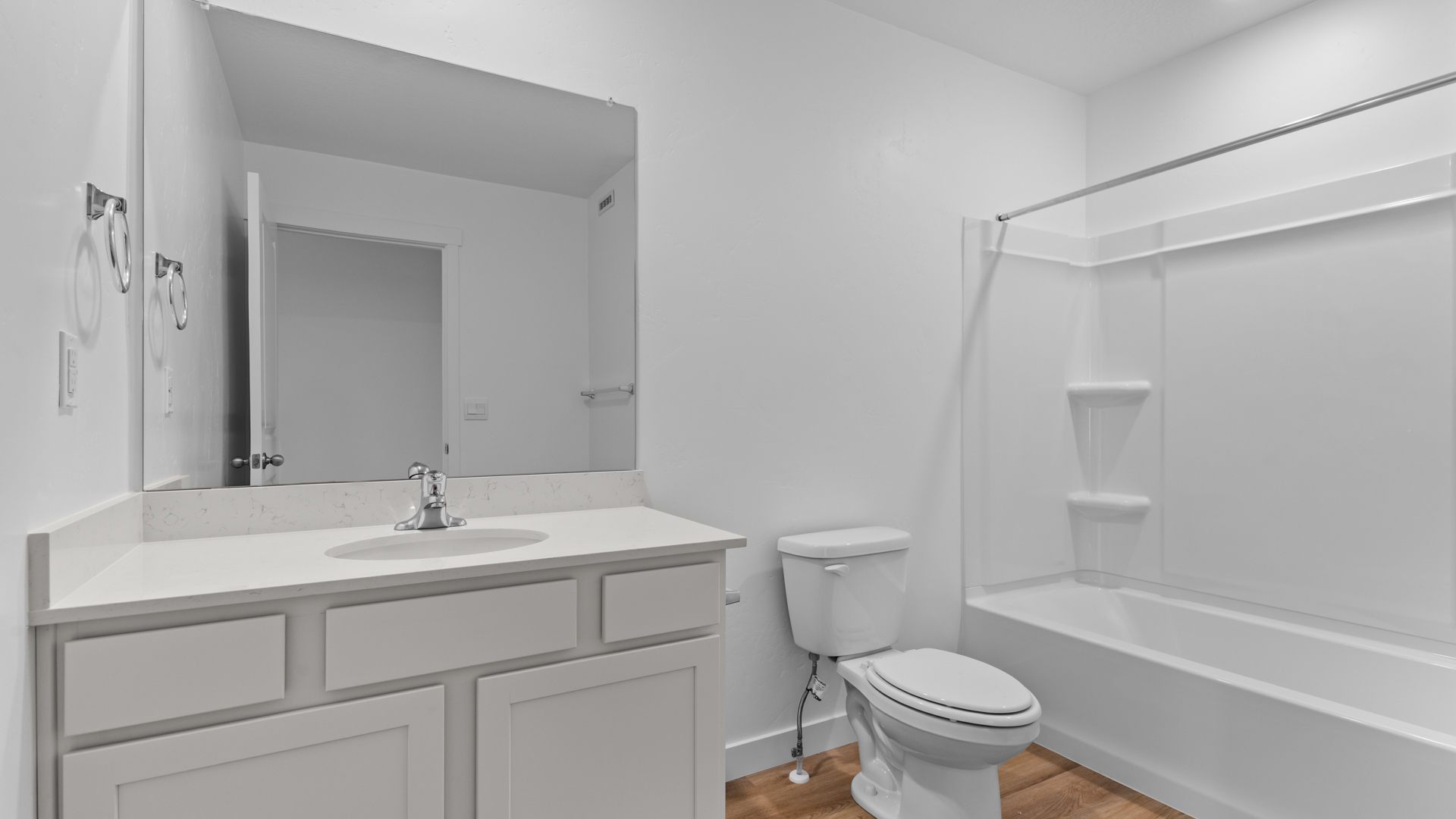 Bathroom with vanity and shower surround.