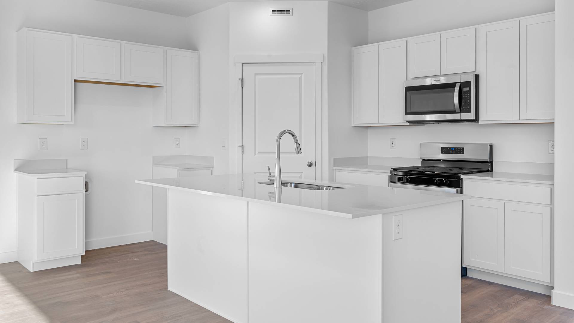Kitchen with kitchen island and two tone cabinets.