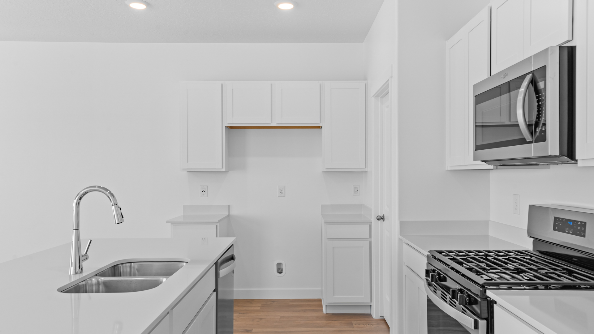 Kitchen space with ktichen island and stainless steel appliances.