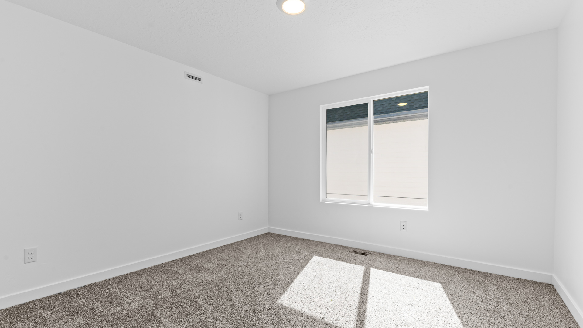 Bedroom with large window.