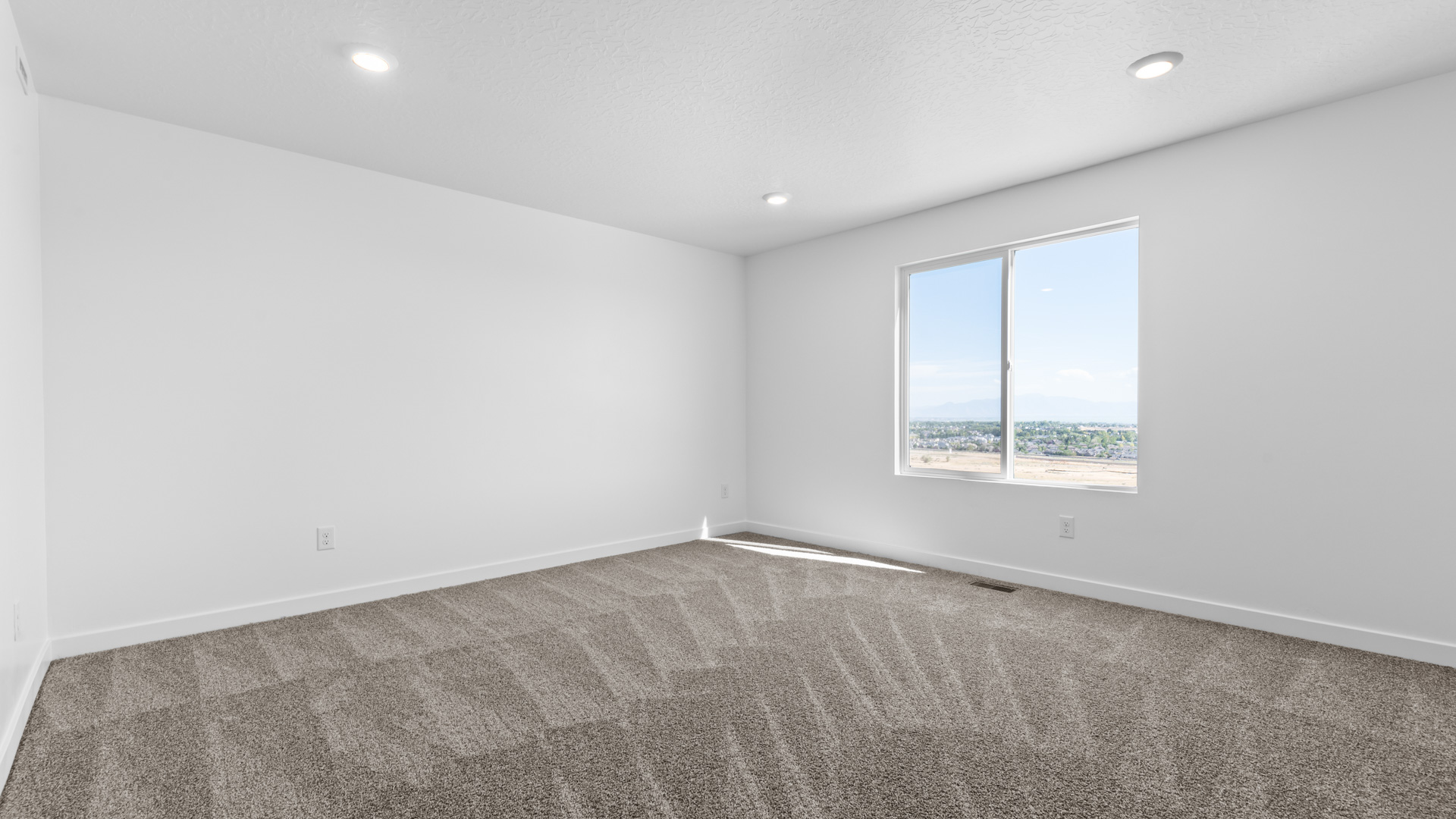 Primary bedroom with large window.