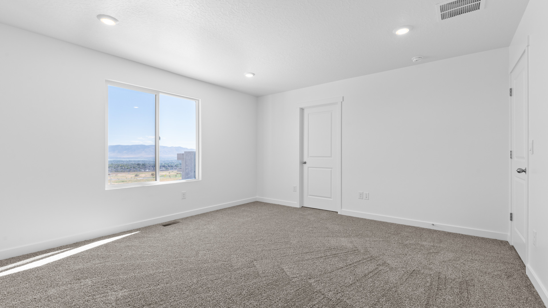Primary bedroom with large window.
