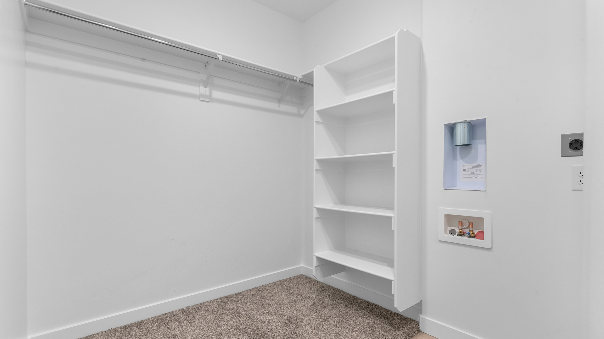 Spacious walk-in closet with laundry setup
