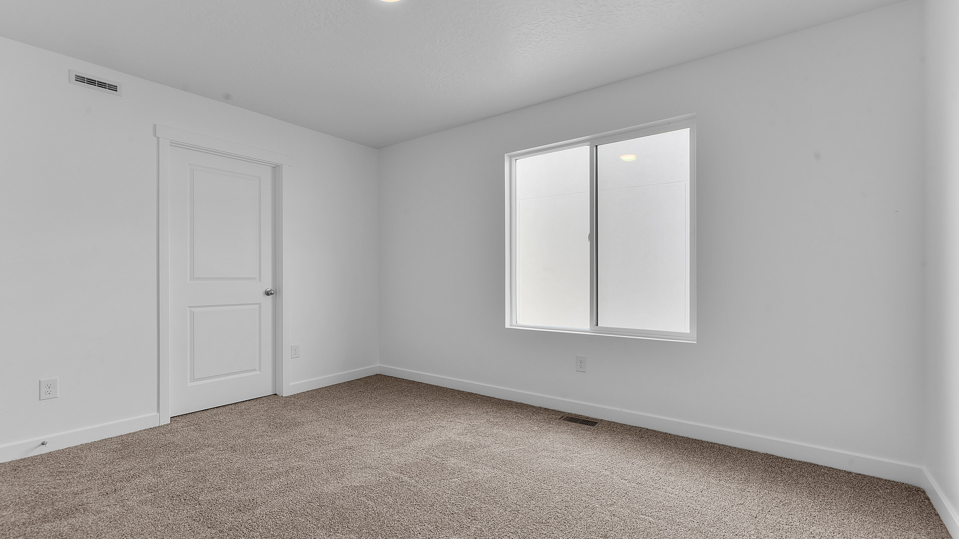 Bedroom with large window.