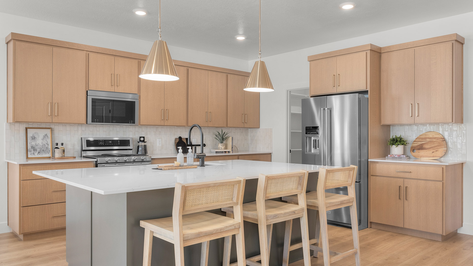 Kitchen area with kitchen island and kitchen cabinets.