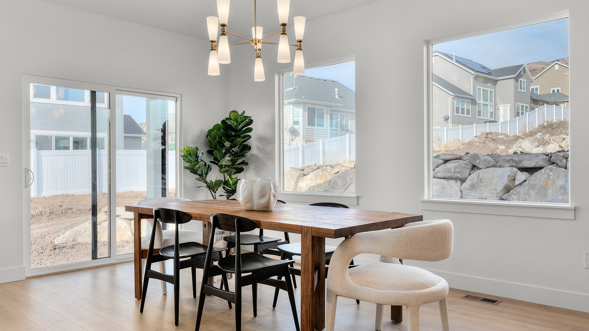 Dining room with patio doors and large windows.