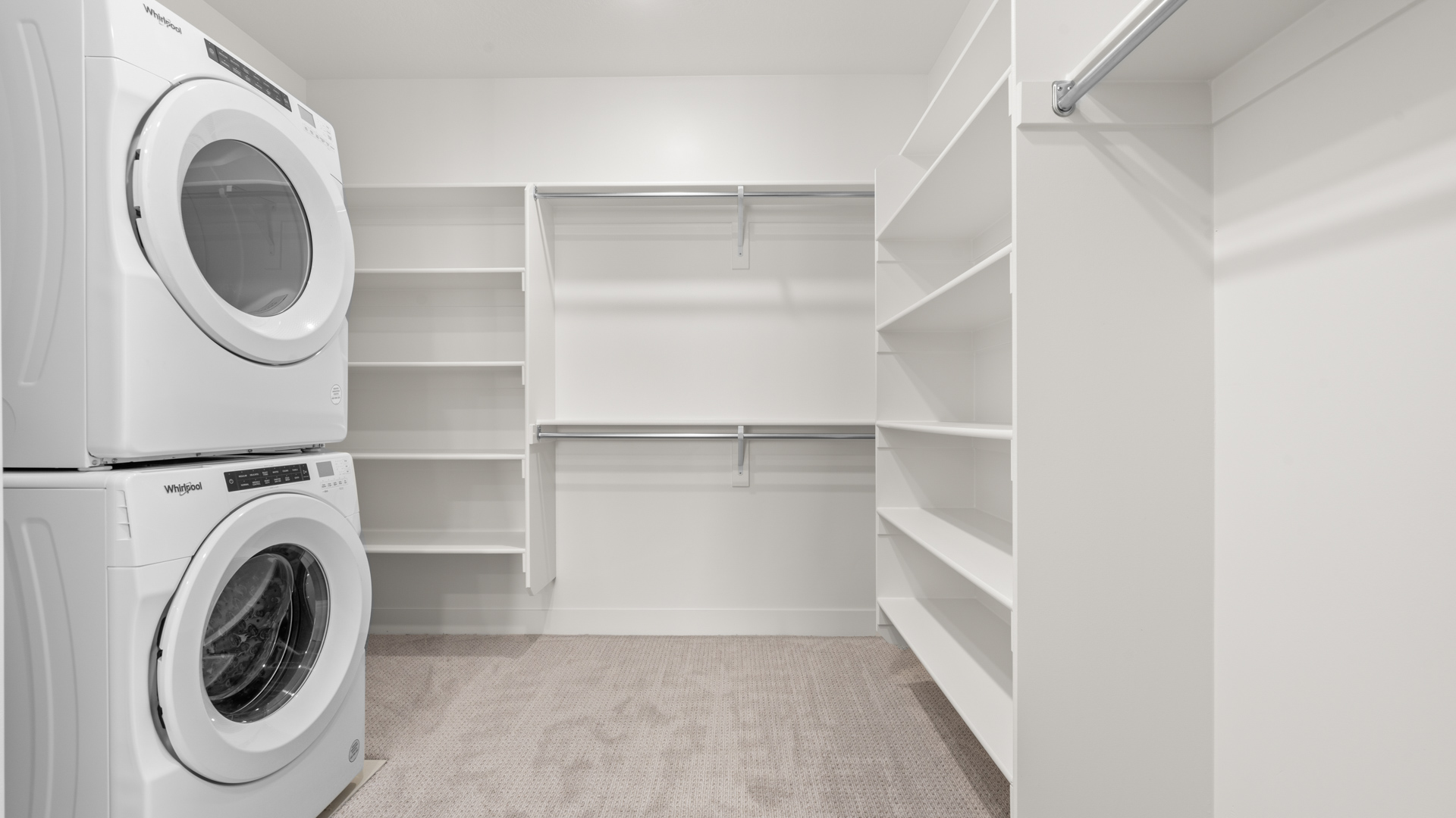 Primary walk-in closet with laundry setup.