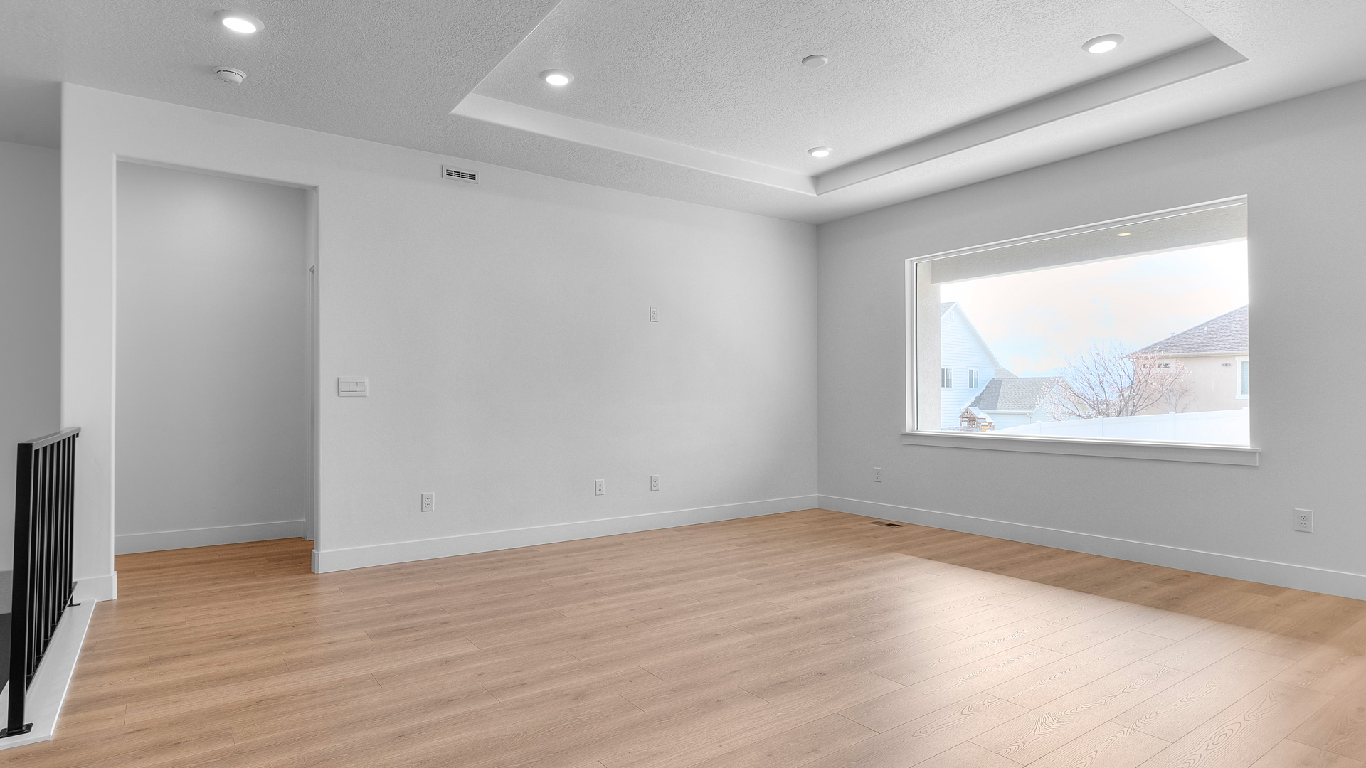 Main living space with tray ceilings.