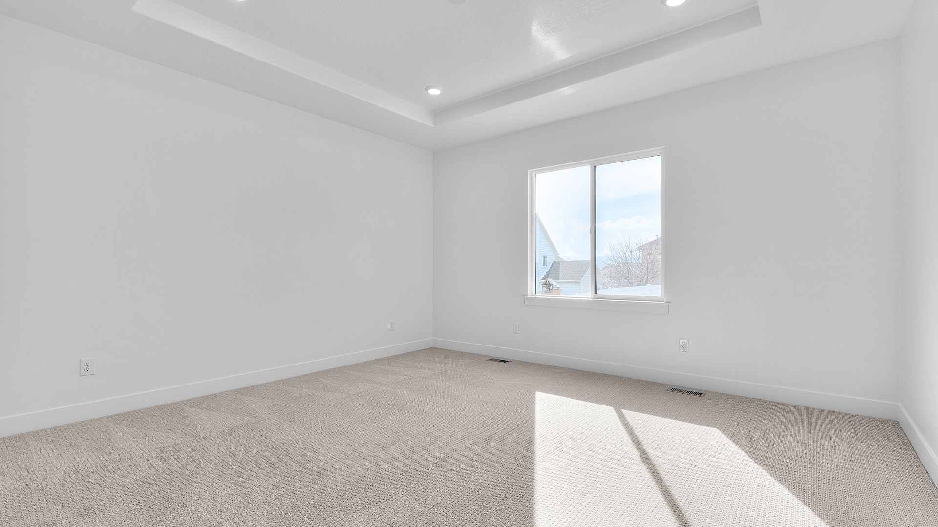 Primary bedroom with tray ceilings.