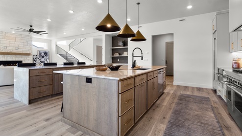 Spacious kitchen with two countertops and stainless steel appliances.