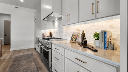 Spacious kitchen with two countertops and stainless steel appliances.
