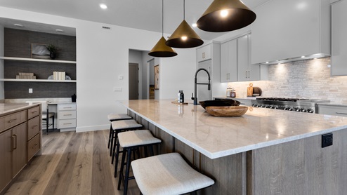 Spacious kitchen with two countertops and stainless steel appliances.