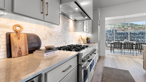 Spacious kitchen with two countertops and stainless steel appliances.