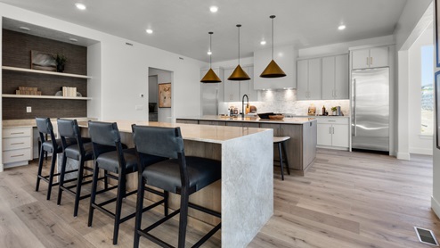 Spacious kitchen with two countertops and stainless steel appliances.