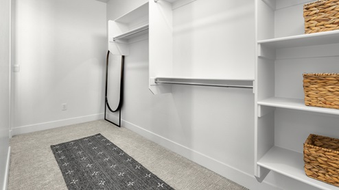 Walk-in closet with two entries.