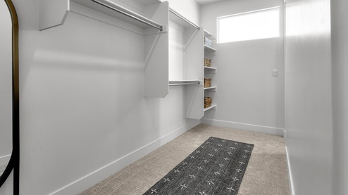 Walk-in closet with two entries.
