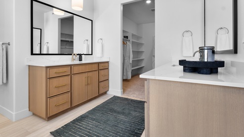 Primary bathroom with two vanities.