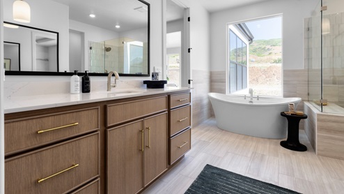 Primary bathroom with two vanities.